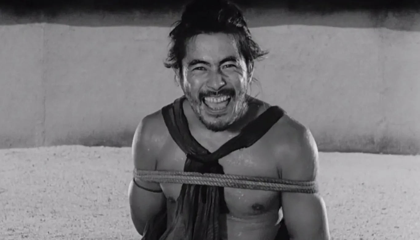 A bound man laughing defiantly, a scene of contested testimony, in Akira Kurosawa's Rashomon (1950)