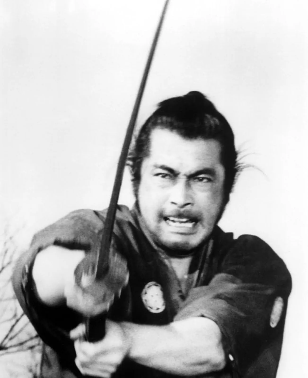The ronin mid-strike, teeth gritted, sword extended, in a scene from Akira Kurosawa's Yojimbo (1961)