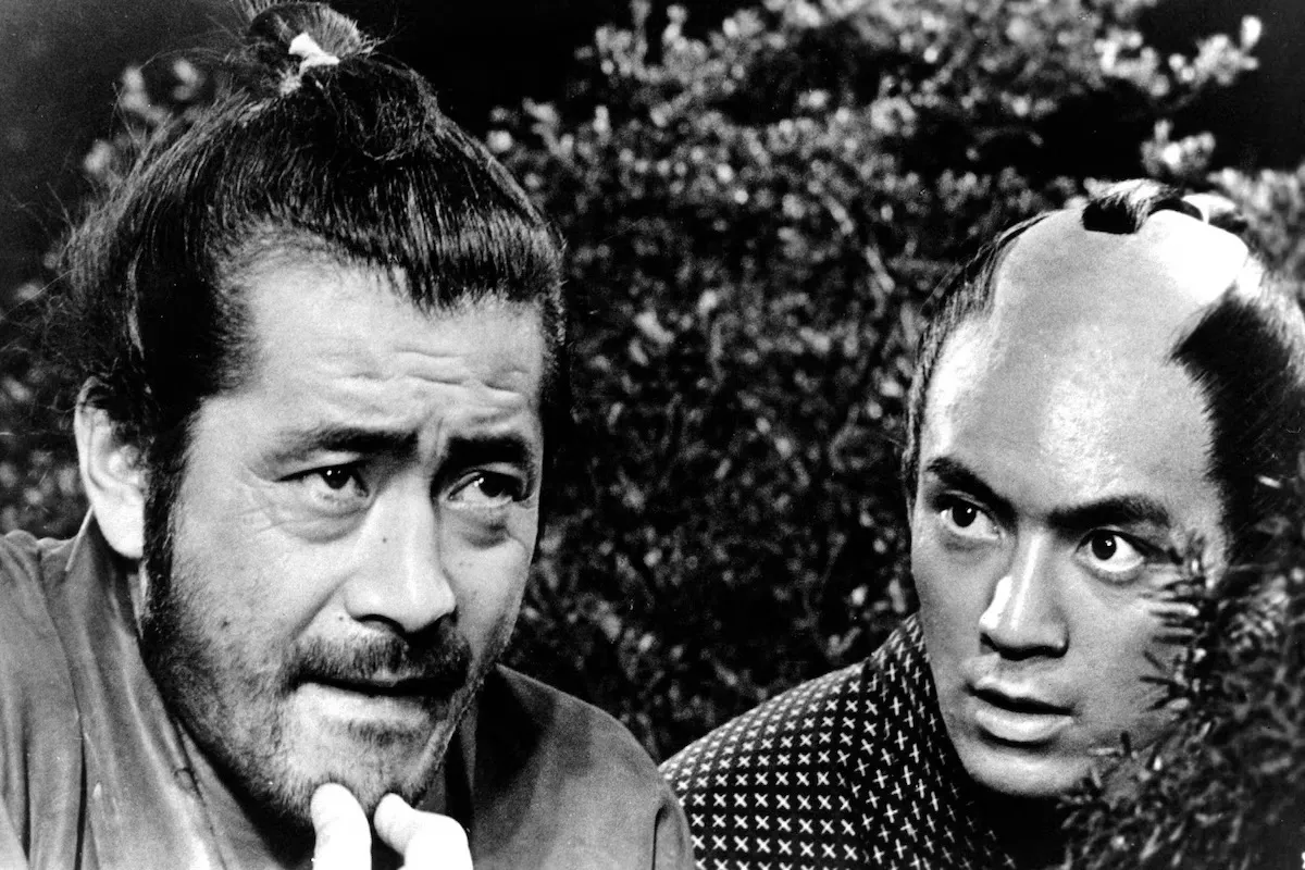 Sanjuro pauses, hand to chin, weighing his next move, from Akira Kurosawa's Sanjuro (1962)